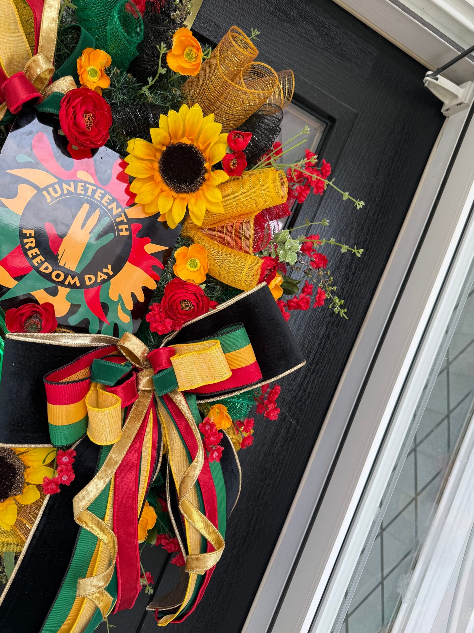 Beautifully designed wreath with a mix of colorful flowers and green leaves.