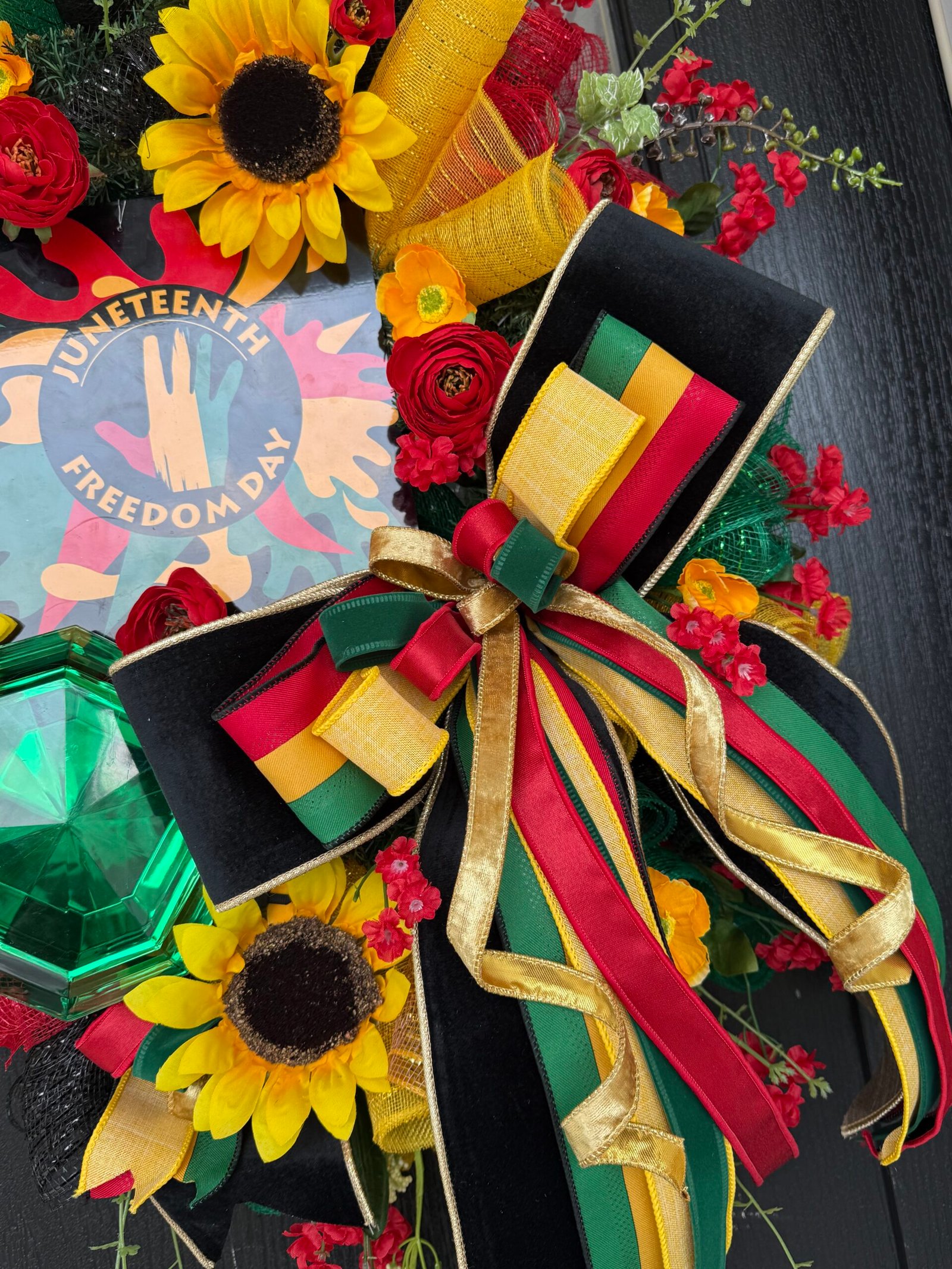 Handcrafted floral wreath with vibrant seasonal flowers and greenery.